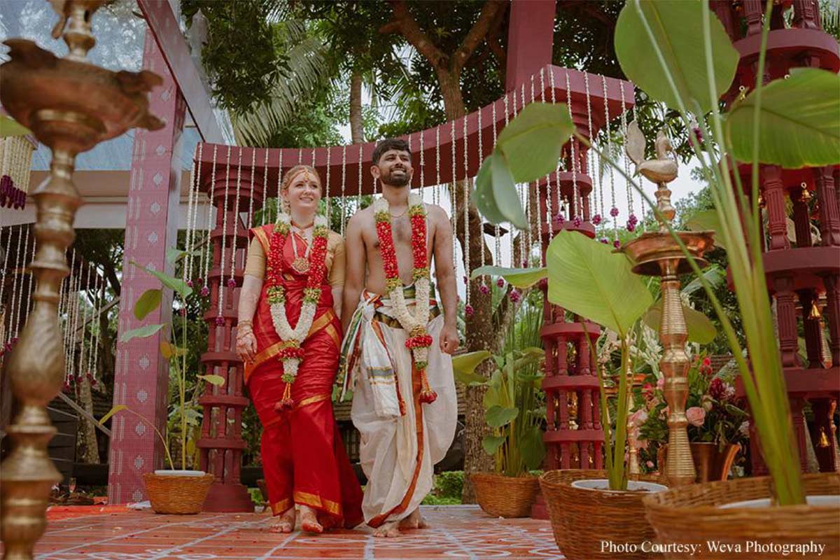 Framed by tranquil backwaters, this cross-cultural wedding came alive with the culture and verdant beauty of Kerala!