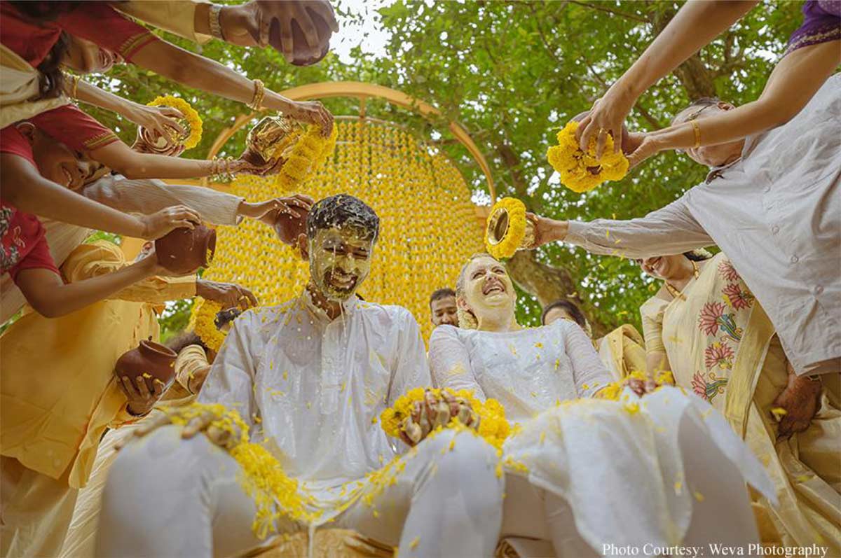 Framed by tranquil backwaters, this cross-cultural wedding came alive with the culture and verdant beauty of Kerala!